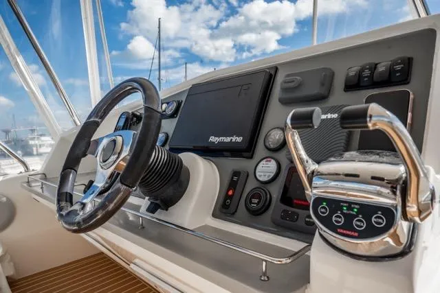 Slide: The Image of Cockpit of 2017 Leopard 51 Powercat with Raymarine navigation system and steering wheel. - 40
