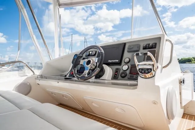 Slide: The Image of Helm of 2017 Leopard 51 Powercat with modern navigation equipment and steering wheel. - 41