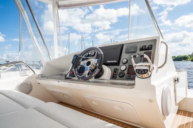 Slide: The Image of Helm of 2017 Leopard 51 Powercat with modern navigation equipment and scenic water view. - 42