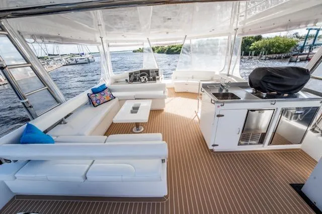 Slide: The Image of Luxurious 2017 Leopard 51 Powercat yacht interior with white seating and kitchenette. - 43
