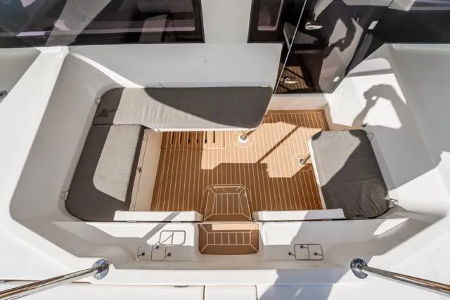 Slide: The Image of 2017 Leopard 51 Powercat deck with cushioned seating and teak flooring. - 49