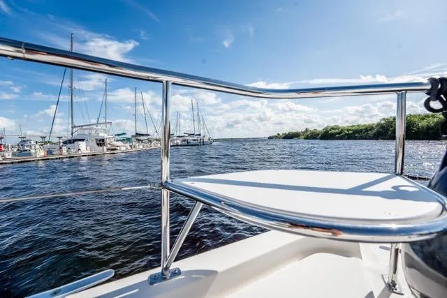 Slide: The Image of 2017 Leopard 51 Powercat on water, marina view, sunny day, blue sky, sailboats in background. - 52