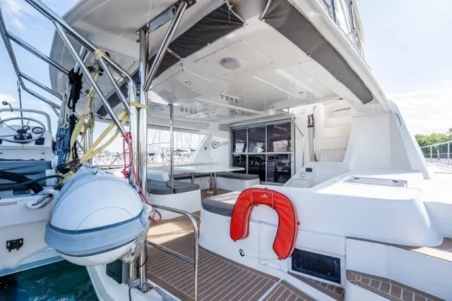 Slide: The Image of 2017 Leopard 51 Powercat yacht deck with seating, life preserver, and helm station. - 55