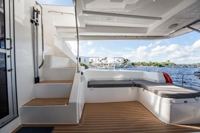 Slide: The Image of Leopard 51 Powercat 2017 yacht interior with seating and stairs, overlooking water. - 57