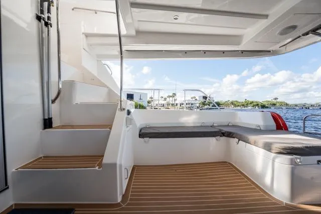 Slide: The Image of 2017 Leopard 51 Powercat interior with seating, stairs, and scenic water view. - 58