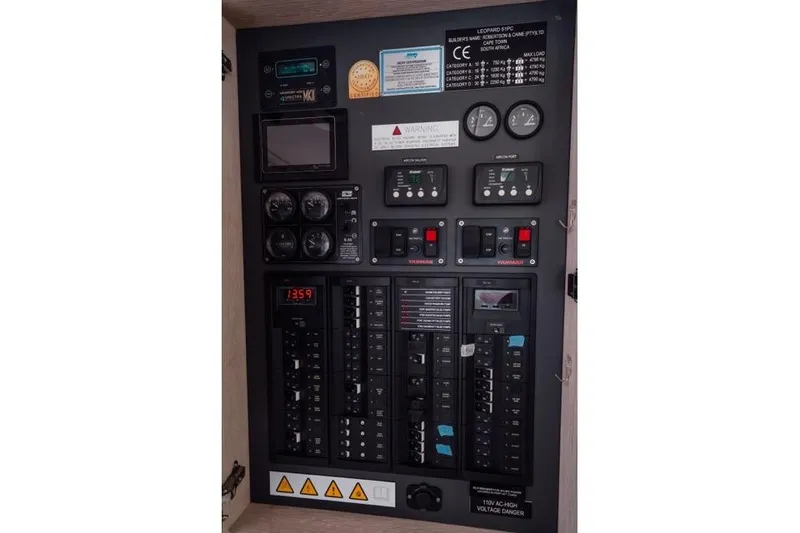 Slide: The Image of Electrical control panel of a 2017 Leopard 51 Powercat yacht, featuring gauges and switches. - 76
