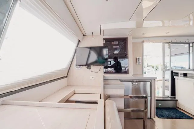 Slide: The Image of Interior of 2017 Leopard 51 Powercat yacht with modern furnishings and a mounted TV. - 78