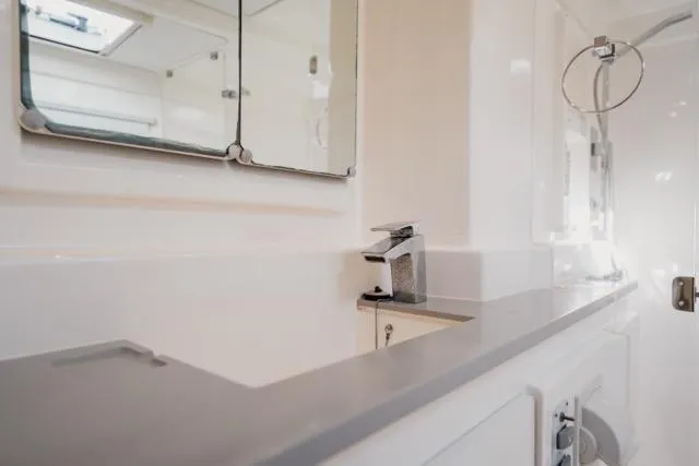 Slide: The Image of Modern bathroom interior on 2017 Leopard 51 Powercat yacht, featuring sleek fixtures and mirror. - 97