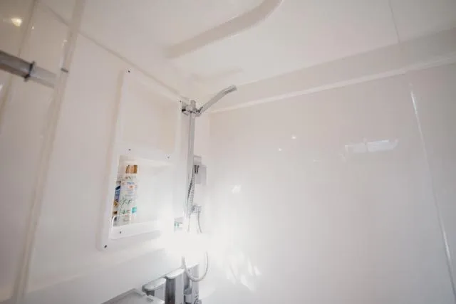 Slide: The Image of Shower area in 2017 Leopard 51 Powercat yacht, featuring sleek white design and modern fixtures. - 98