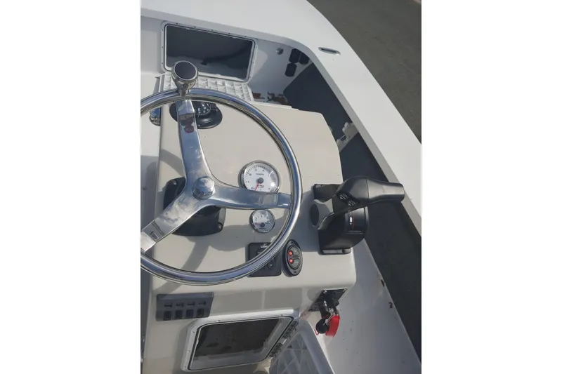 Slide: The Image of 2026 Mitzi Skiffs 17 Tournament boat console with steering wheel and controls. - 7