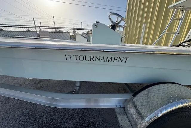 Slide: The Image of 2026 Mitzi Skiffs 17 Tournament boat on trailer, side view near building. - 8