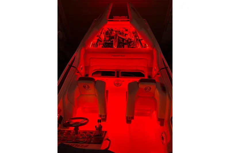 Slide: The Image of 2004 Fountain 42 Lightning boat interior with red ambient lighting. - 10