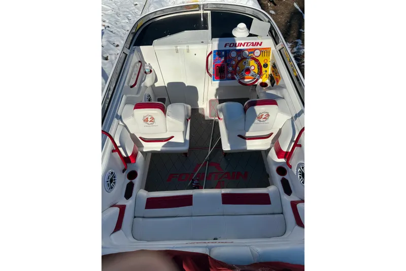 Slide: The Image of 2004 Fountain 42 Lightning boat interior with red and white seating, vibrant dashboard. - 12
