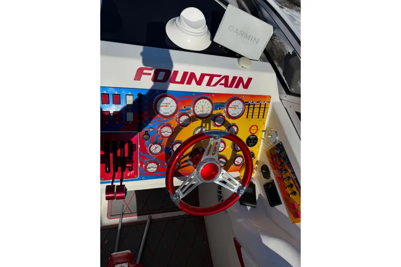Slide: The Image of 2004 Fountain 42 Lightning boat dashboard with colorful gauges and Garmin navigation system. - 13