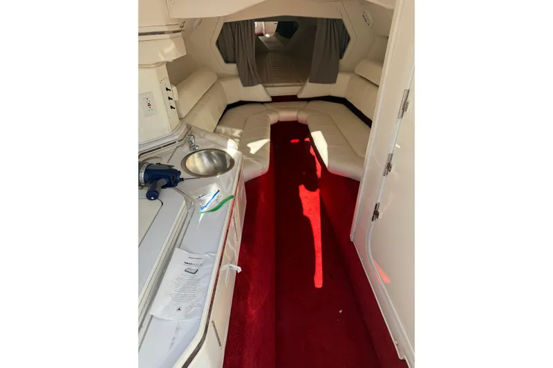 Slide: The Image of 2004 Fountain 42 Lightning boat interior with red carpet and white seating. - 17