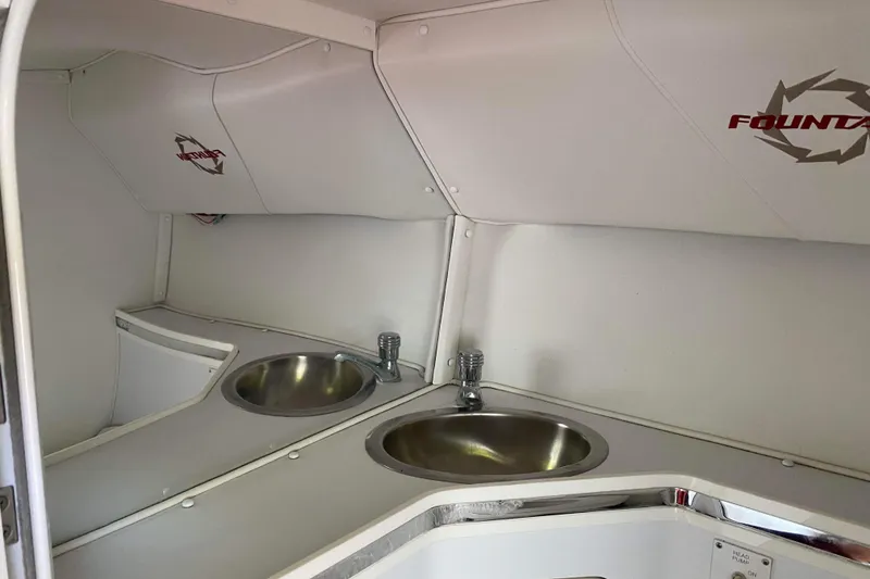 Slide: The Image of 2004 Fountain 42 Lightning boat interior with dual sinks and sleek design. - 19