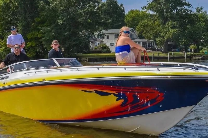 Slide: The Image of 2004 Fountain 42 Lightning speedboat with vibrant design, cruising on a sunny day. - 4