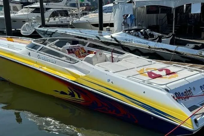 Slide: The Image of 2004 Fountain 42 Lightning speedboat with vibrant yellow and red design docked at marina. - 5