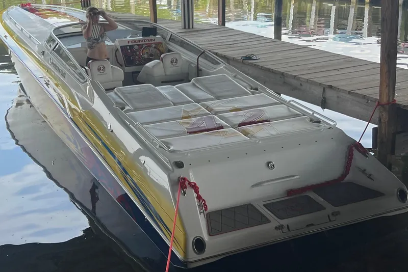 Slide: The Image of 2004 Fountain 42 Lightning speedboat docked, featuring sleek design and vibrant colors. - 6
