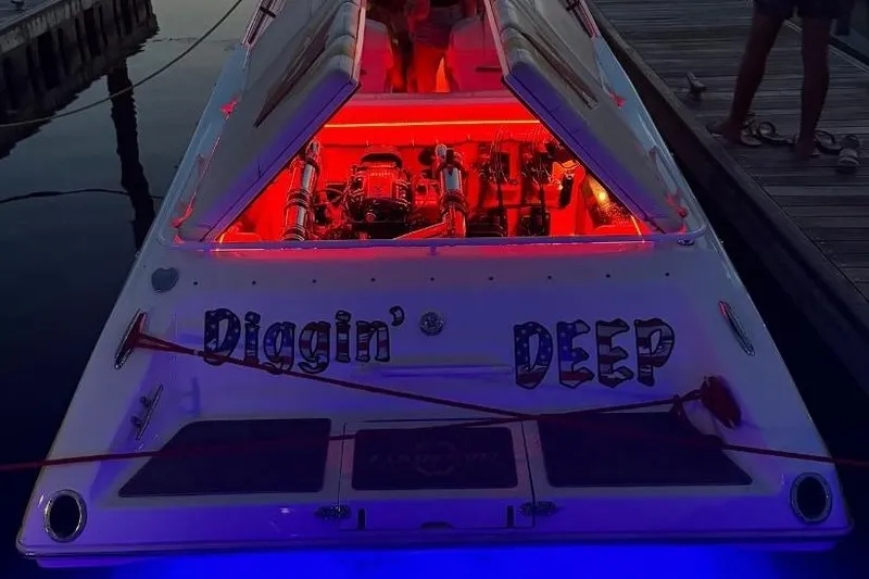 Slide: The Image of 2004 Fountain 42 Lightning boat with illuminated engine compartment at dock, displaying "Diggin' Deep." - 9