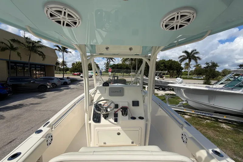 Slide: The Image of 2021 Cobia 237 Center Console boat interior with steering wheel and electronics. - 12