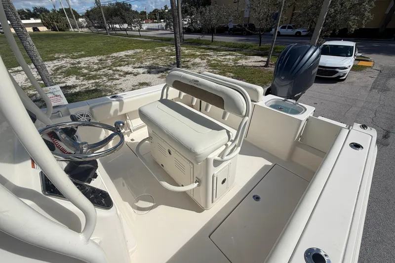 Slide: The Image of 2021 Cobia 237 Center Console boat interior with steering wheel and seating. - 13