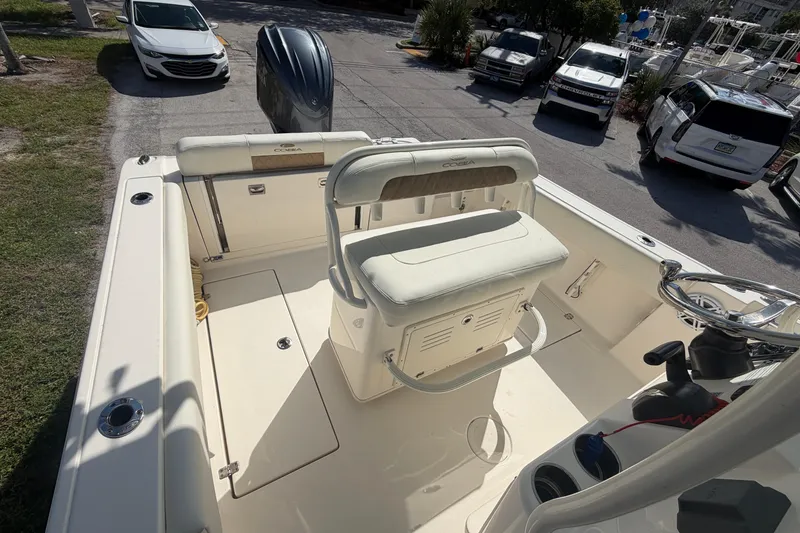 Slide: The Image of 2021 Cobia 237 Center Console boat interior with seating and steering wheel. - 14