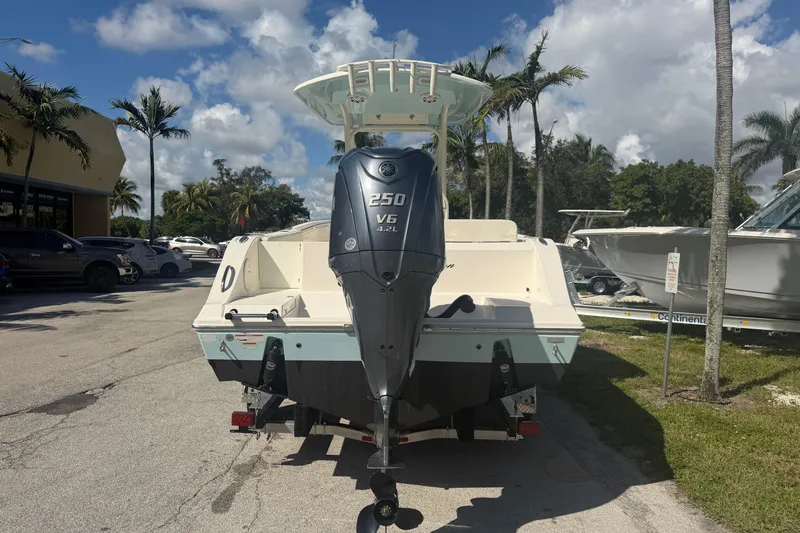 Slide: The Image of 2021 Cobia 237 Center Console boat with Yamaha 250 V6 engine, parked outdoors. - 3