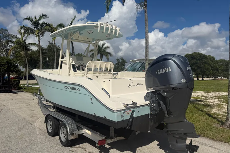 Slide: The Image of 2021 Cobia 237 Center Console boat with Yamaha engine on trailer. - 4