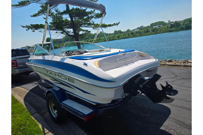 Slide: The Image of 2003 Tahoe Q5L boat on trailer by a scenic lakeside road. - 1