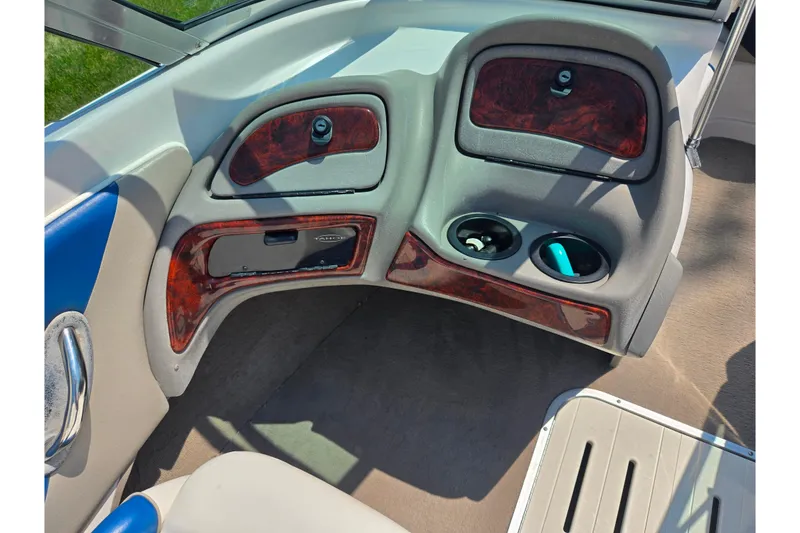Slide: The Image of Interior of a 2003 Tahoe Q5L boat with wood accents and cup holders. - 13