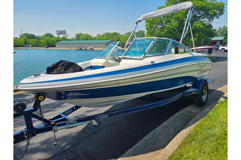 Slide: The Image of 2003 Tahoe Q5L boat on trailer by a lakeside, sunny day. - 8
