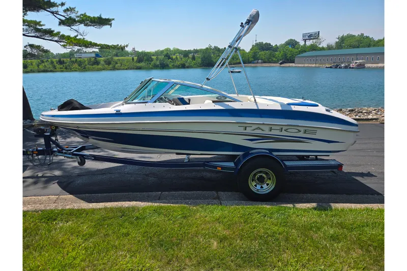 Slide: The Image of 2003 Tahoe Q5L boat on trailer by a scenic lake. - 9