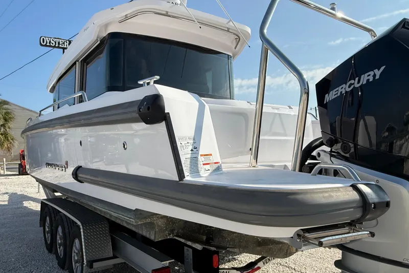 Slide: The Image of 2023 Axopar 37 XC CROSS CABIN boat with Mercury engine on trailer. - 11