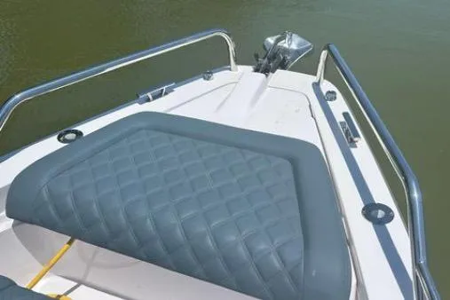 Slide: The Image of 2023 Axopar 37 XC CROSS CABIN boat bow with cushioned seating and stainless steel railings. - 18