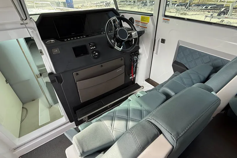 Slide: The Image of Interior of 2023 Axopar 37 XC CROSS CABIN, featuring modern helm and seating. - 20