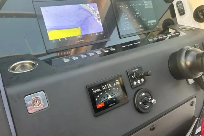 Slide: The Image of Control panel of 2023 Axopar 37 XC CROSS CABIN with navigation screens and controls. - 23