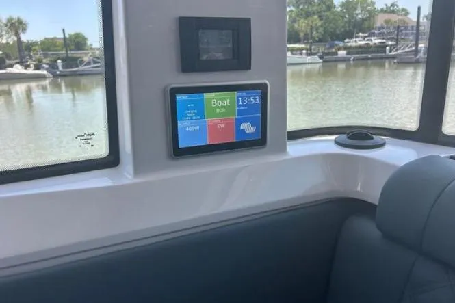 Slide: The Image of Interior of 2023 Axopar 37 XC CROSS CABIN with digital display and waterfront view. - 26