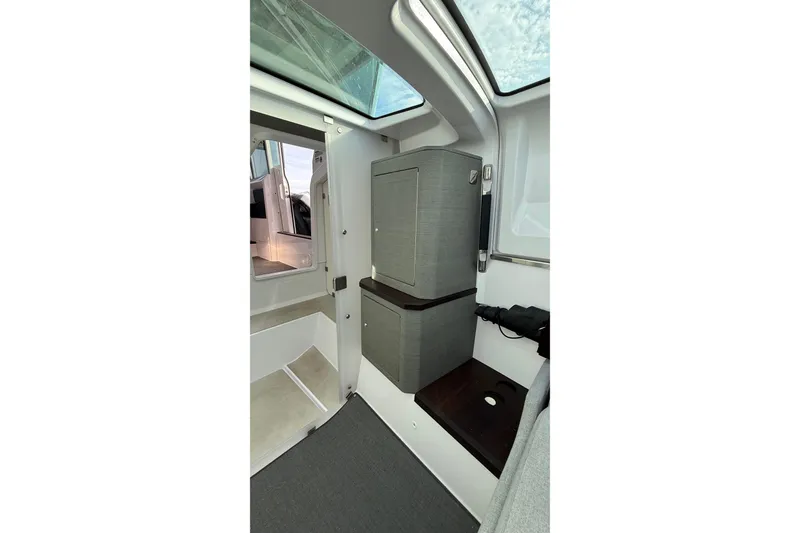 Slide: The Image of Interior of 2023 Axopar 37 XC CROSS CABIN, featuring modern cabinetry and skylight. - 33