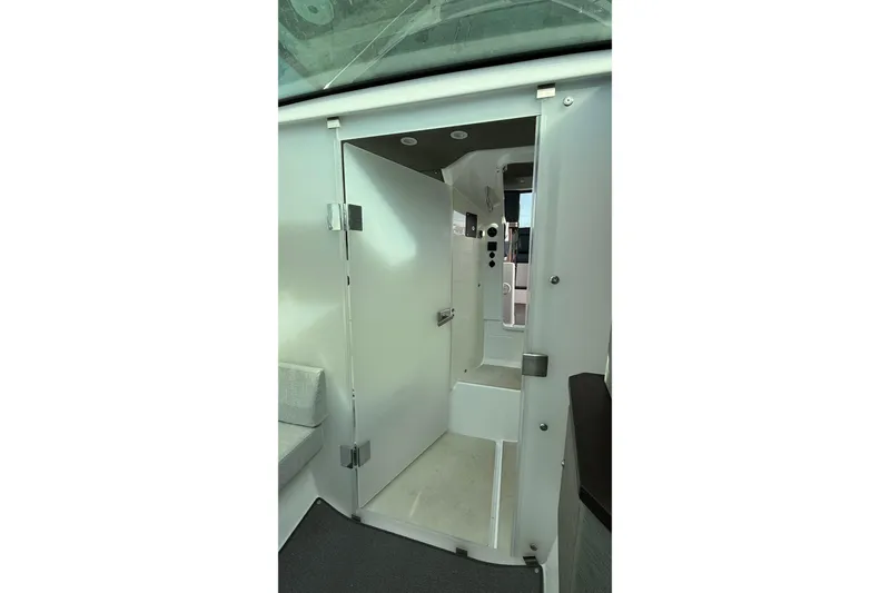 Slide: The Image of Interior view of 2023 Axopar 37 XC CROSS CABIN, featuring sleek white design. - 35