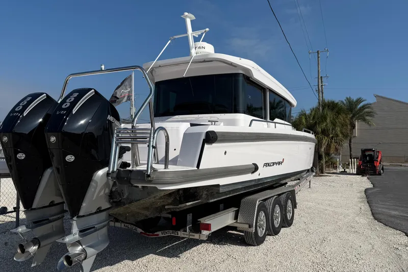 Slide: The Image of 2023 Axopar 37 XC CROSS CABIN boat on trailer with dual engines. - 7