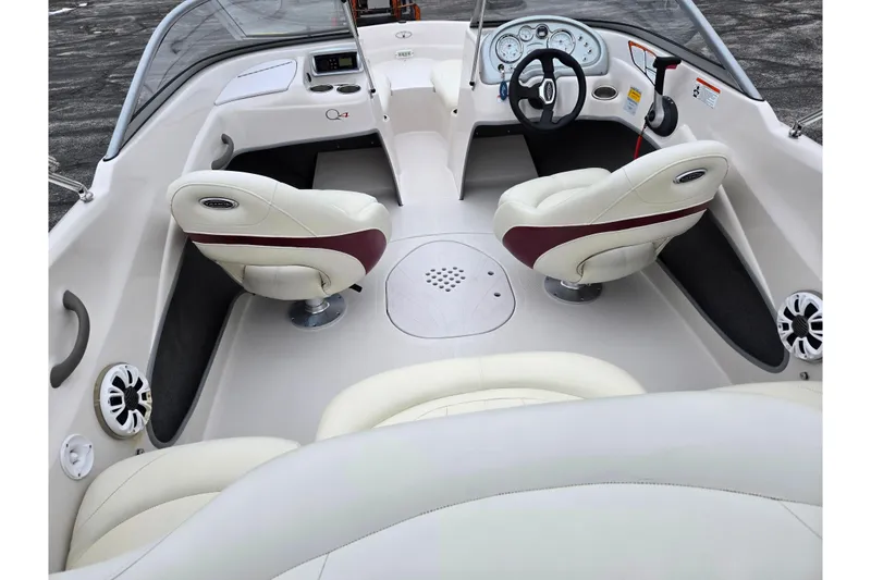 Slide: The Image of 2011 Tahoe Q4 SS boat interior with white and maroon seats, steering wheel, and dashboard. - 24