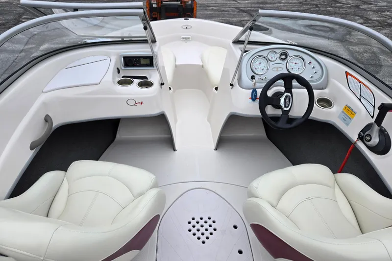 Slide: The Image of 2011 Tahoe Q4 SS boat interior with steering wheel, gauges, and white seating. - 25