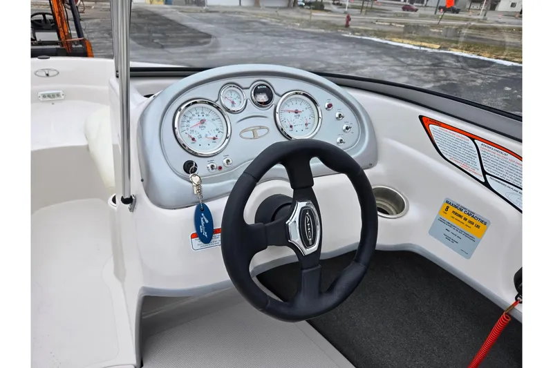 Slide: The Image of Steering wheel and dashboard of 2011 Tahoe Q4 SS boat, featuring gauges and controls. - 27