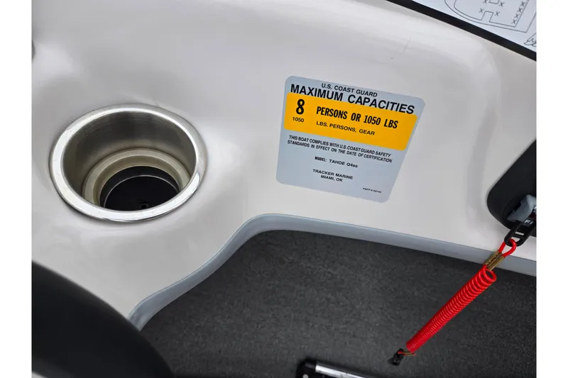 Slide: The Image of 2011 Tahoe Q4 SS boat capacity label, cup holder, and safety lanyard. - 28