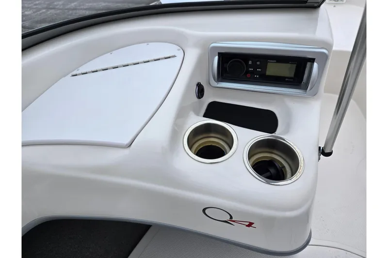 Slide: The Image of 2011 Tahoe Q4 SS boat dashboard with stereo and cup holders. - 29
