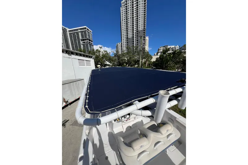 Slide: The Image of 2008 Donzi 38 ZFX Open boat with blue cover, urban skyline background. - 10