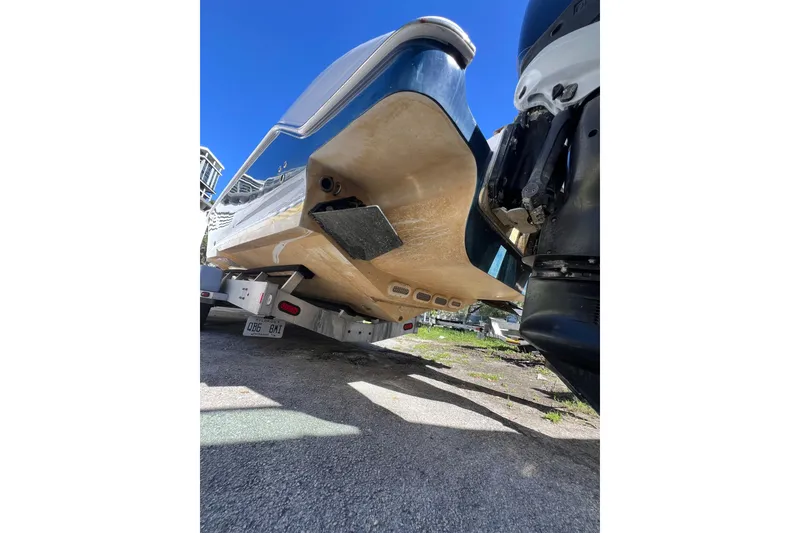Slide: The Image of 2008 Donzi 38 ZFX Open boat on trailer, viewed from below, showcasing hull and outboard motor. - 15