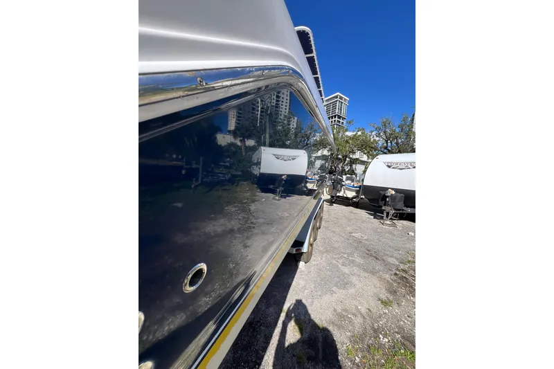 Slide: The Image of 2008 Donzi 38 ZFX Open boat side view with shiny hull and urban background. - 18