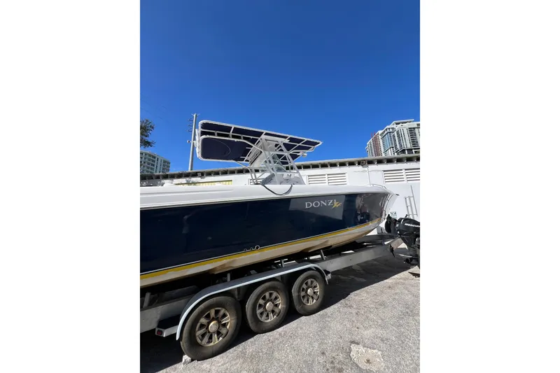 Slide: The Image of 2008 Donzi 38 ZFX Open boat on trailer under clear blue sky. - 19